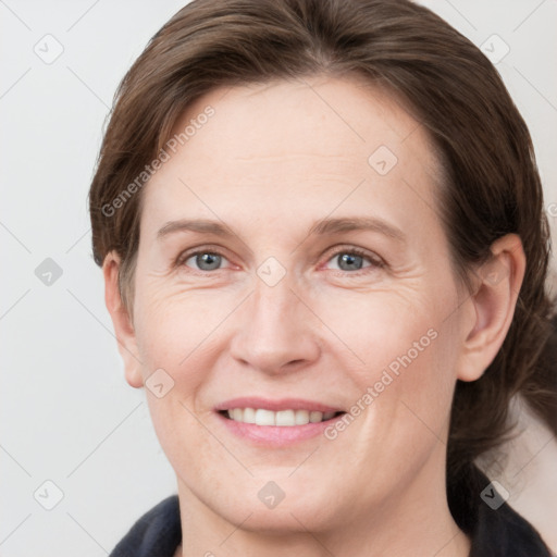 Joyful white adult female with medium  brown hair and grey eyes