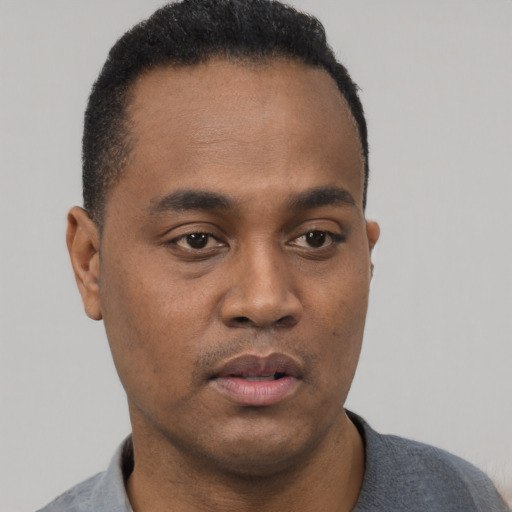 Neutral black young-adult male with short  black hair and brown eyes