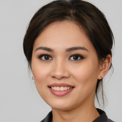 Joyful white young-adult female with medium  brown hair and brown eyes