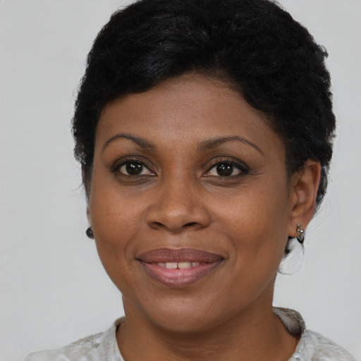 Joyful black adult female with short  brown hair and brown eyes