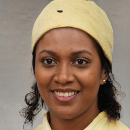 Joyful black young-adult female with medium  brown hair and brown eyes