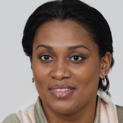 Joyful black young-adult female with medium  brown hair and brown eyes