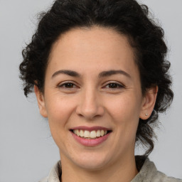 Joyful white adult female with medium  brown hair and brown eyes