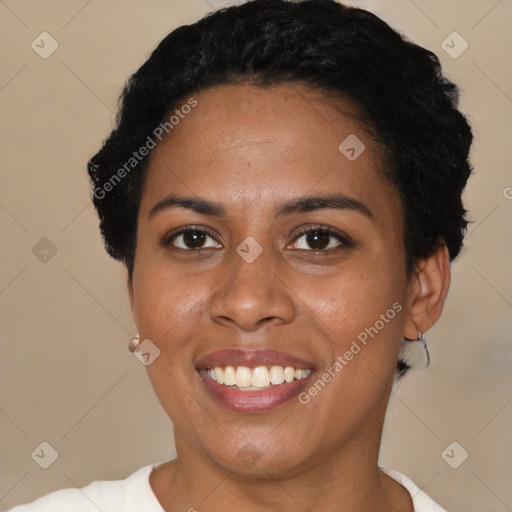 Joyful black young-adult female with short  black hair and brown eyes