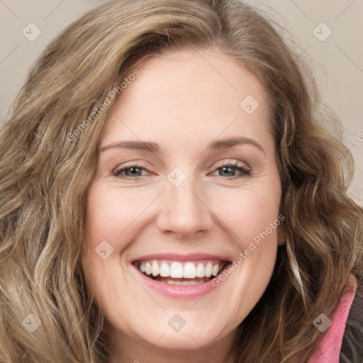 Joyful white young-adult female with long  brown hair and green eyes