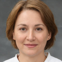 Joyful white adult female with medium  brown hair and brown eyes