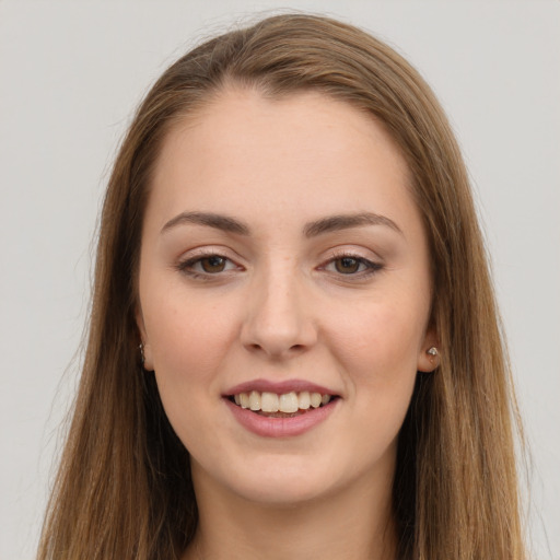 Joyful white young-adult female with long  brown hair and brown eyes