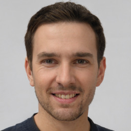 Joyful white young-adult male with short  brown hair and brown eyes