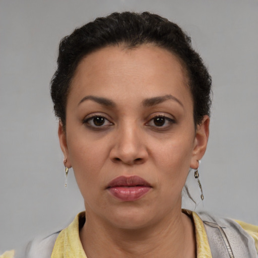 Joyful latino adult female with short  brown hair and brown eyes