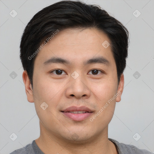 Joyful asian young-adult male with short  brown hair and brown eyes