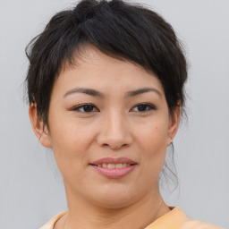 Joyful asian young-adult female with medium  brown hair and brown eyes