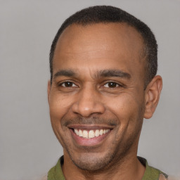 Joyful latino adult male with short  brown hair and brown eyes
