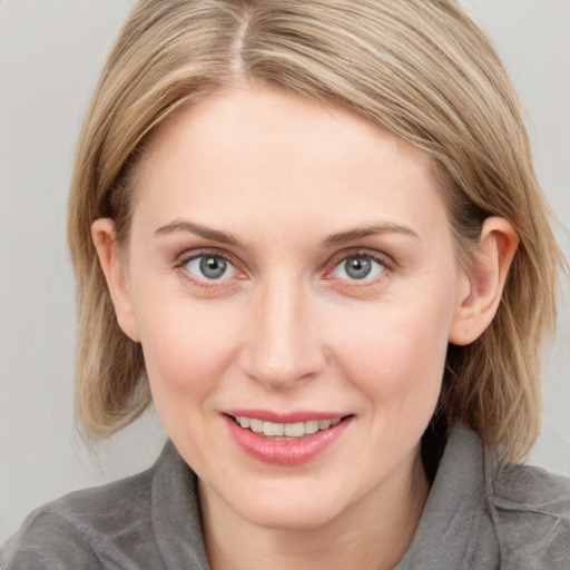 Joyful white young-adult female with medium  brown hair and blue eyes