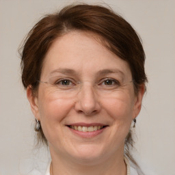 Joyful white adult female with medium  brown hair and grey eyes