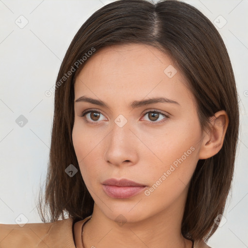 Neutral white young-adult female with long  brown hair and brown eyes