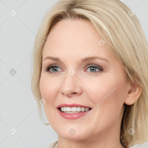 Joyful white young-adult female with long  brown hair and blue eyes