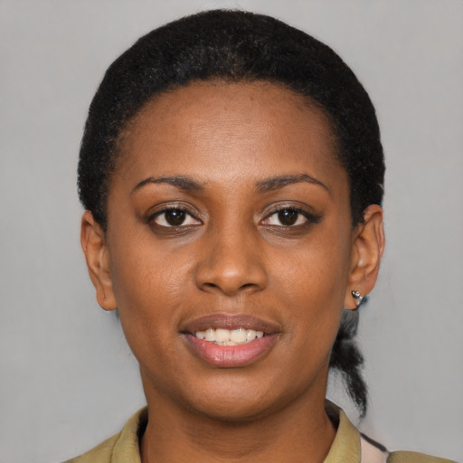 Joyful latino young-adult female with short  black hair and brown eyes