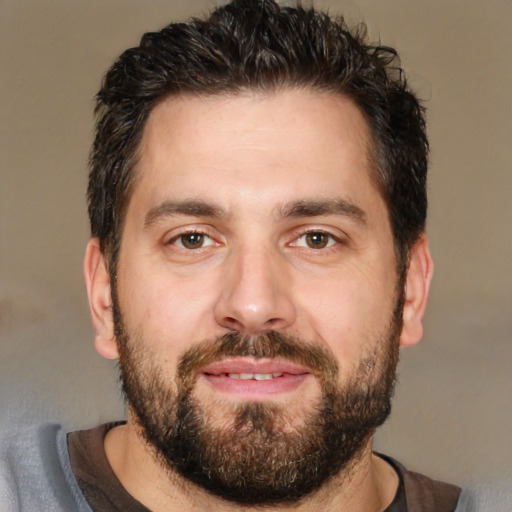 Joyful white adult male with short  brown hair and brown eyes