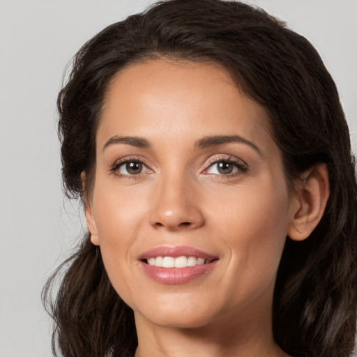 Joyful white young-adult female with long  brown hair and brown eyes