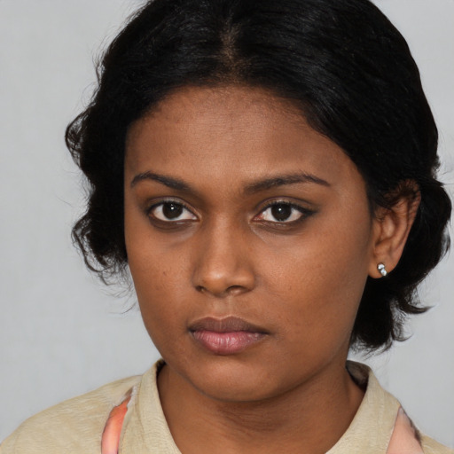 Neutral black young-adult female with medium  black hair and brown eyes