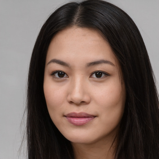 Joyful asian young-adult female with long  brown hair and brown eyes