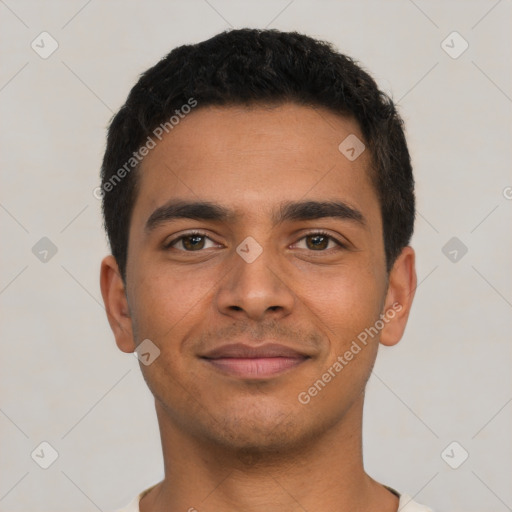 Joyful latino young-adult male with short  black hair and brown eyes