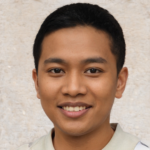 Joyful asian young-adult male with short  black hair and brown eyes