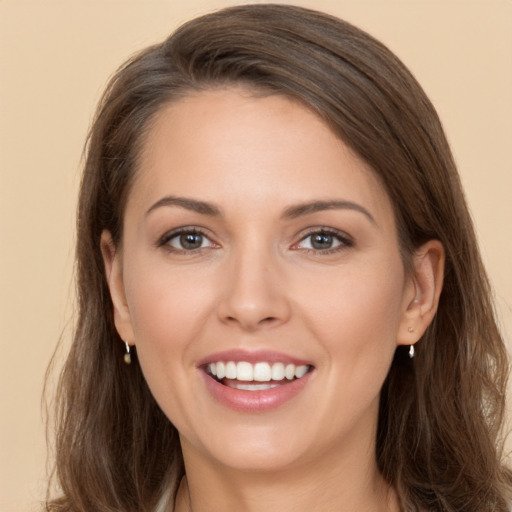 Joyful white young-adult female with long  brown hair and brown eyes