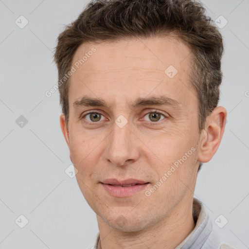 Joyful white adult male with short  brown hair and brown eyes