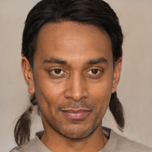Joyful black adult male with short  black hair and brown eyes