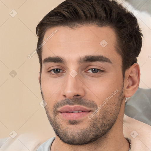 Joyful white young-adult male with short  brown hair and brown eyes