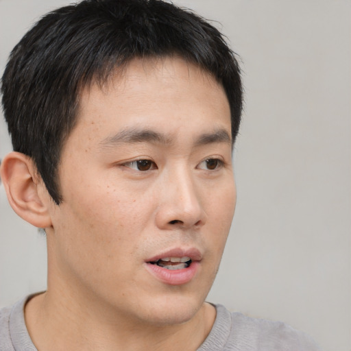 Neutral asian young-adult male with short  brown hair and brown eyes