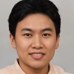 Joyful asian young-adult male with short  black hair and brown eyes