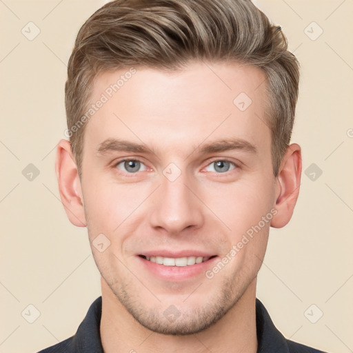 Joyful white young-adult male with short  brown hair and grey eyes