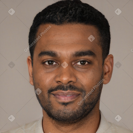 Joyful black young-adult male with short  black hair and brown eyes