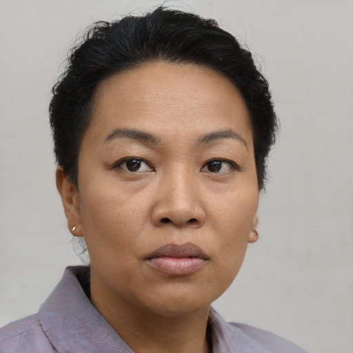 Joyful asian young-adult female with short  black hair and brown eyes