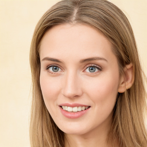 Joyful white young-adult female with long  brown hair and green eyes