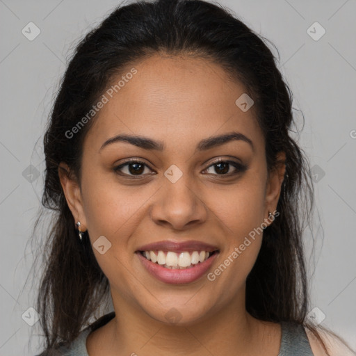 Joyful latino young-adult female with long  brown hair and brown eyes