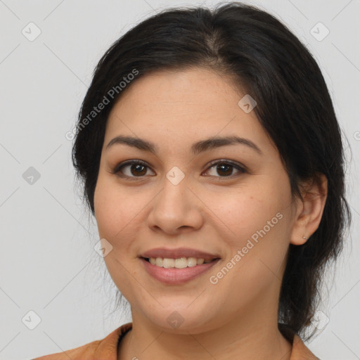 Joyful latino young-adult female with medium  brown hair and brown eyes