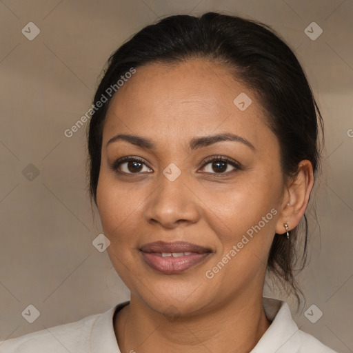 Joyful latino adult female with medium  brown hair and brown eyes