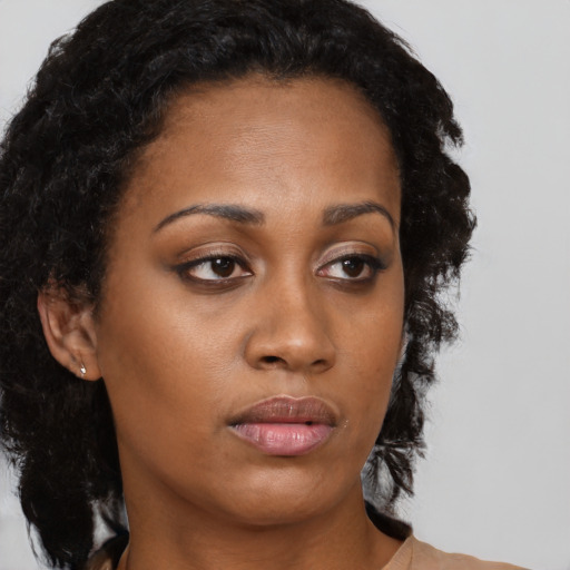 Neutral black young-adult female with long  brown hair and brown eyes