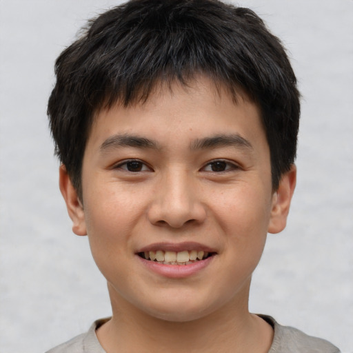 Joyful asian child male with short  brown hair and brown eyes