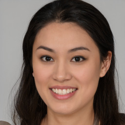 Joyful asian young-adult female with long  brown hair and brown eyes