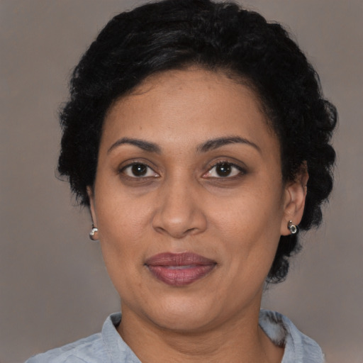 Joyful latino adult female with short  brown hair and brown eyes