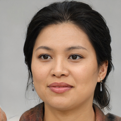 Joyful asian young-adult female with medium  brown hair and brown eyes