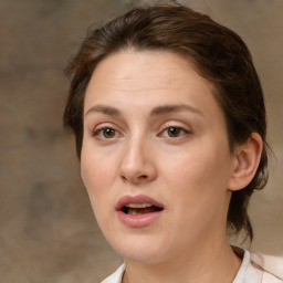 Joyful white adult female with medium  brown hair and brown eyes