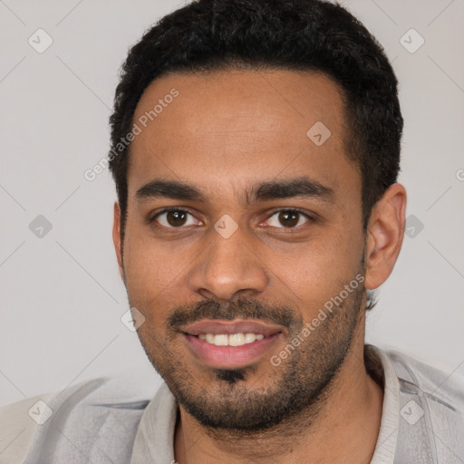 Joyful black young-adult male with short  black hair and brown eyes