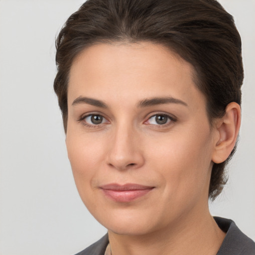 Joyful white young-adult female with medium  brown hair and brown eyes