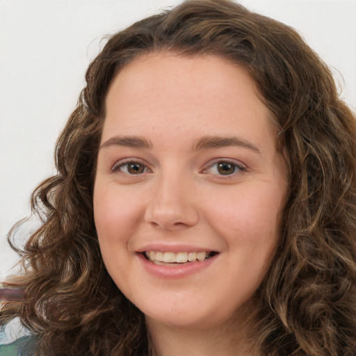 Joyful white young-adult female with long  brown hair and green eyes