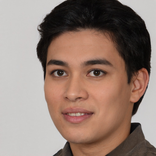 Joyful asian young-adult male with short  brown hair and brown eyes